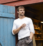 Man standing by blue barn door